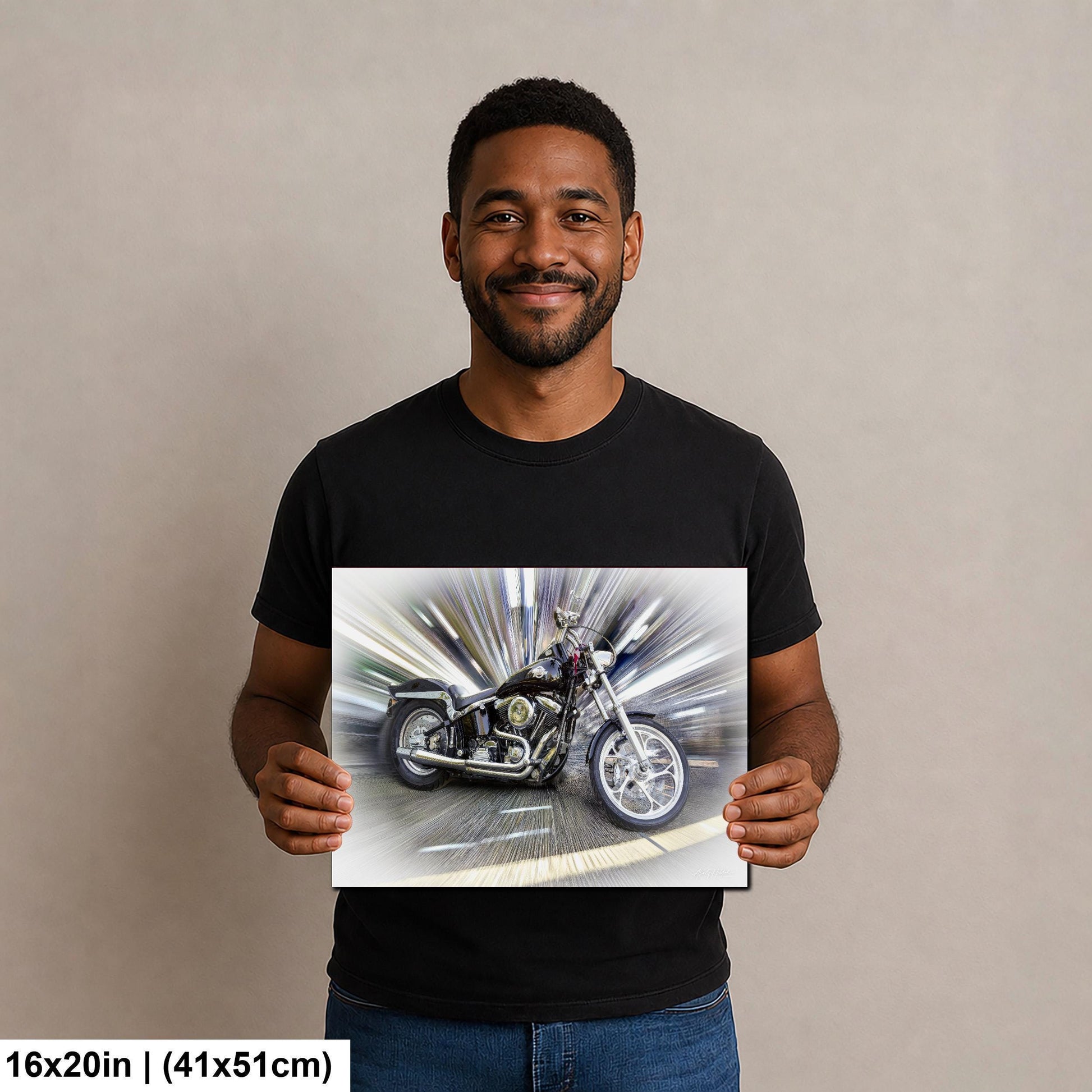 A man is holding a framed print of a motorcycle in front of him.