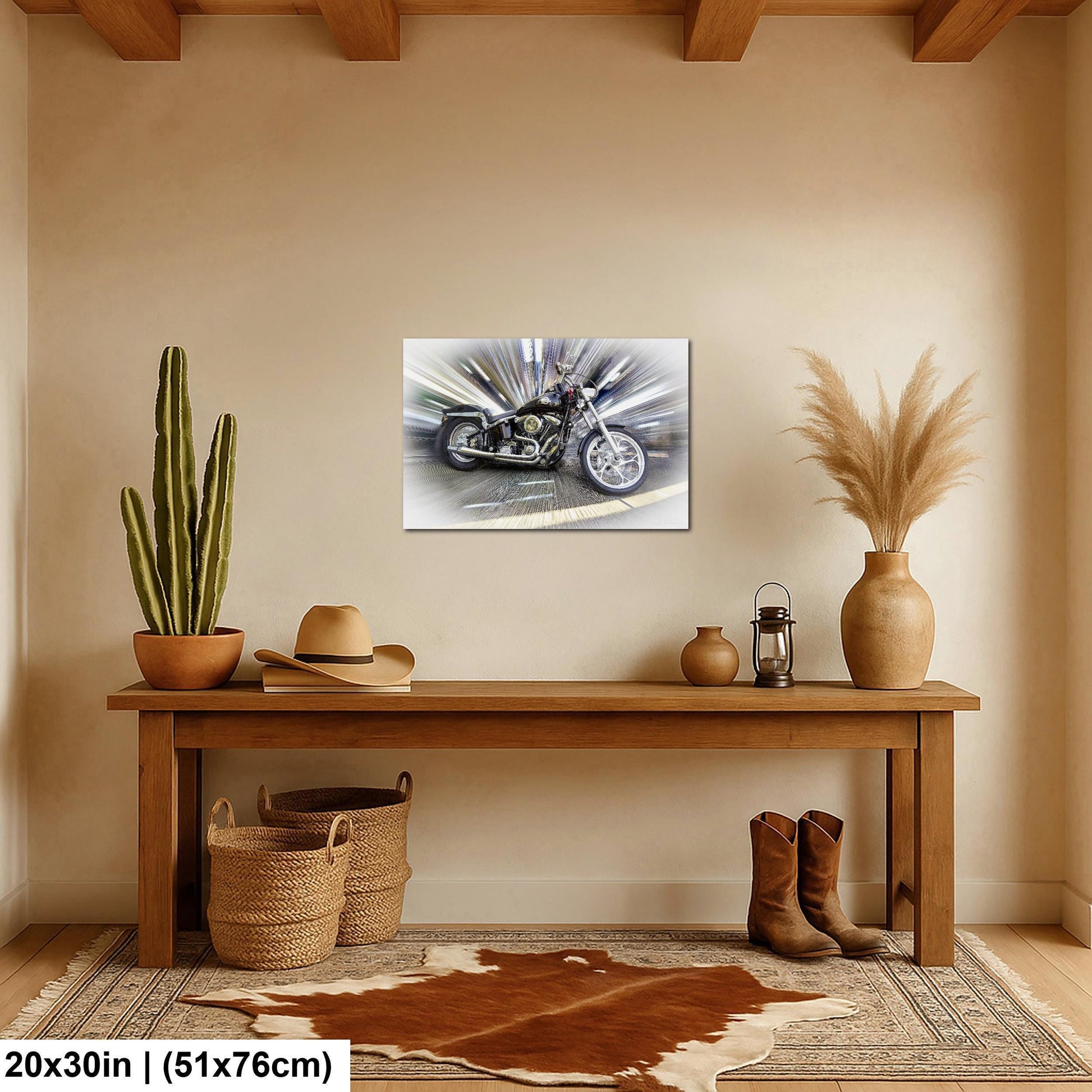 a wooden table with a motorcycle painting hanging on the wall above it. The table also has a potted cactus, a hat, a vase, and a pair of boots on it.