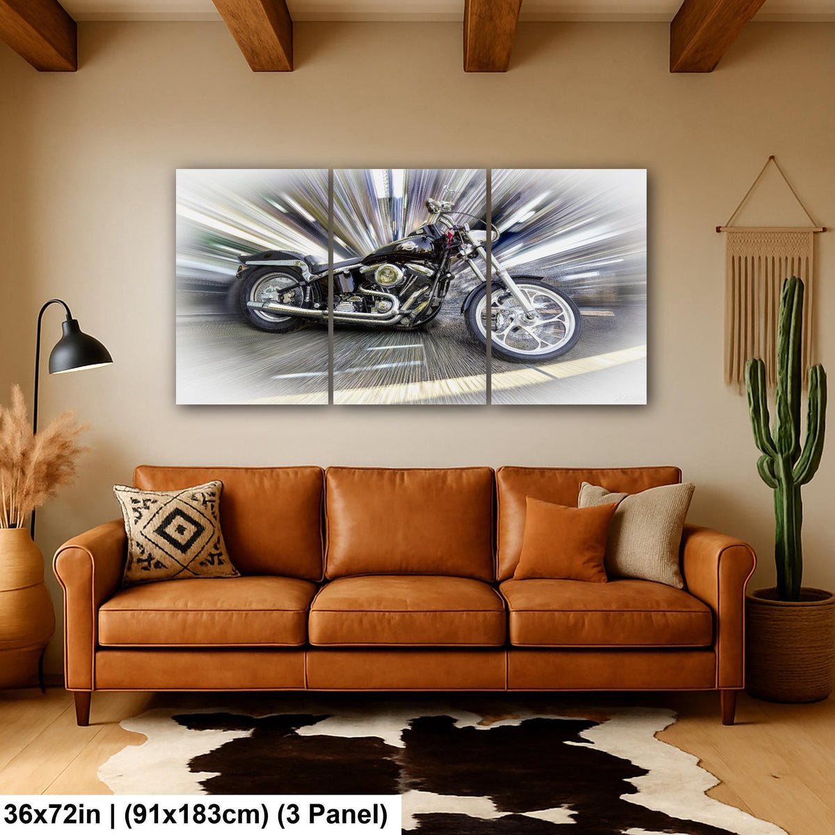 A large, three-panel canvas artwork depicting a motorcycle in motion is displayed on the wall above a brown leather couch in a cozy living room setting.