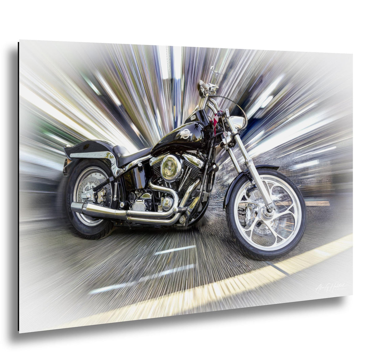 A black and chrome Harley Davidson motorcycle is shown in motion, with a blurred background that creates a sense of speed and movement.