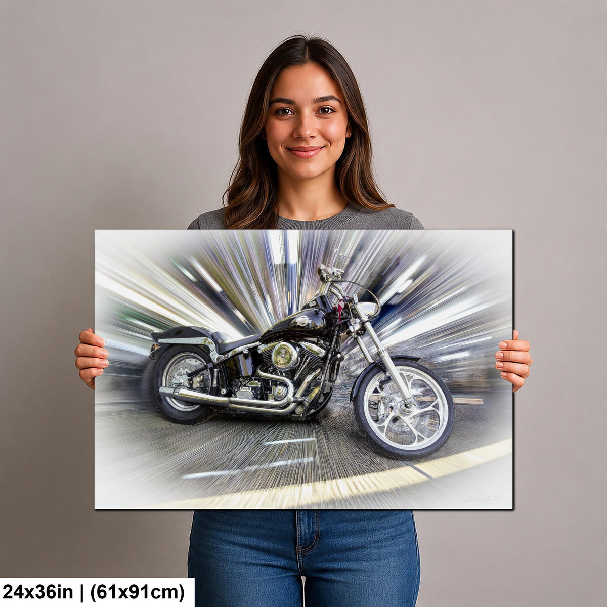 A woman is holding up a framed print of a motorcycle, which appears to be a digital print of a motorcycle in motion.