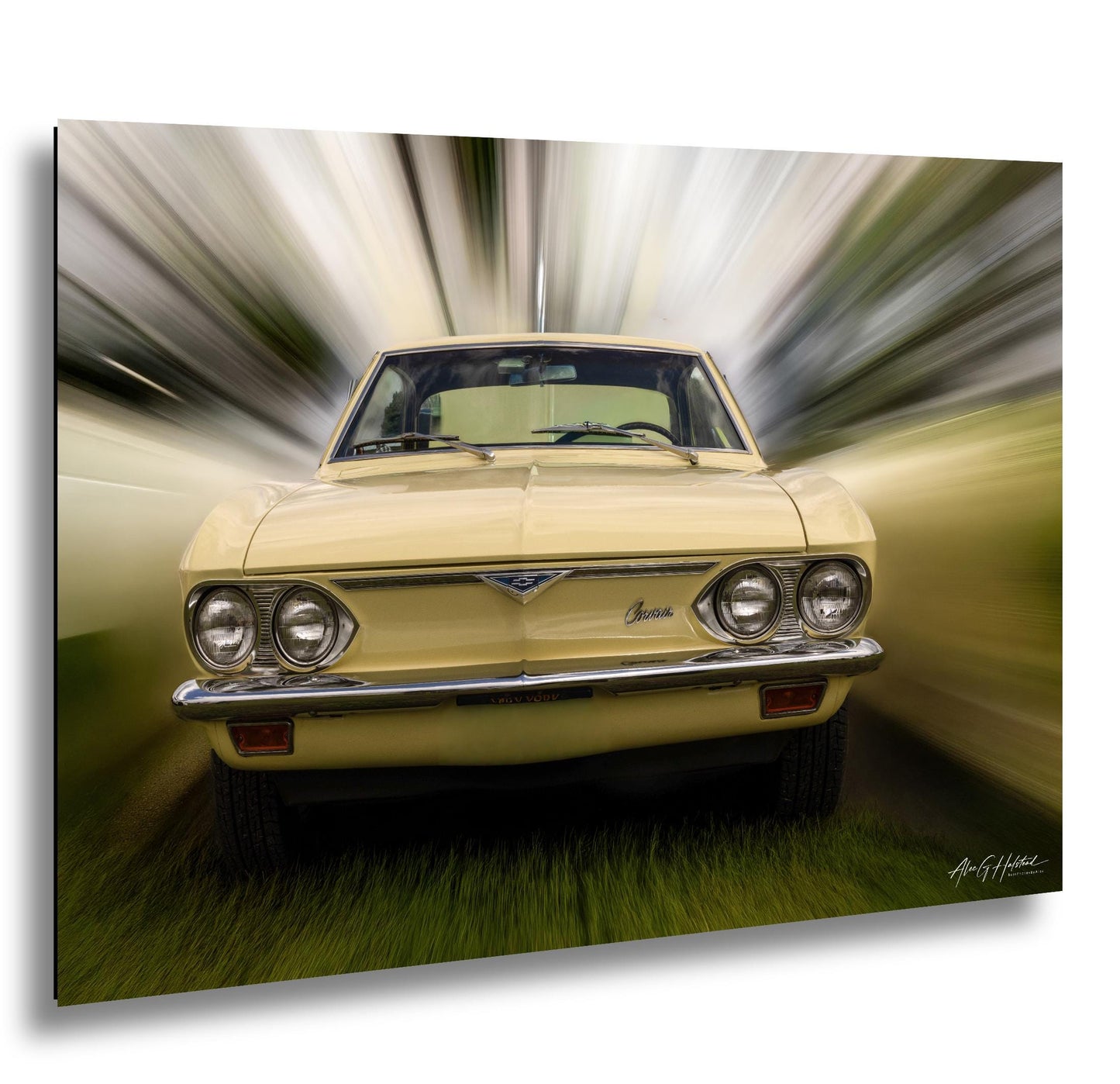 A yellow vintage car with a distinctive V-twin engine is shown in motion, captured in a blurred, fast-moving photograph.