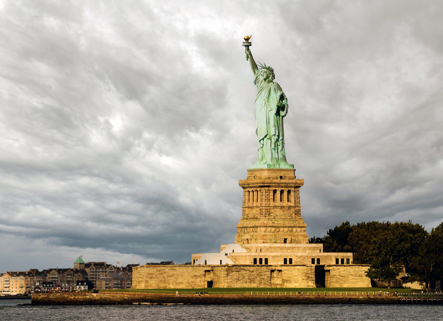 Statue of Liberty guiding light in past storms and the ones coming metal print canvas print color photography daylight sunset  river  poster